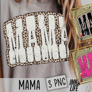 May include: A light gray t-shirt with the word "MAMA" in a distressed white font, outlined with a leopard print design. The image also shows two additional shirt designs with the same graphic in black and pink.