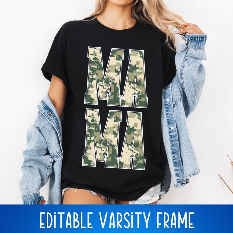 May include: A black t-shirt with the word "MAMA" printed in white letters. The letters are filled with a camouflage pattern in shades of green and brown. The t-shirt is being worn by a person.