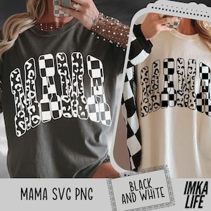 May include: Two long-sleeved shirts with the word "MAMA" in a white, stylized font. The letters are designed with leopard print and checkered patterns. One shirt is dark gray, the other is cream-colored with black and white checkered sleeves.