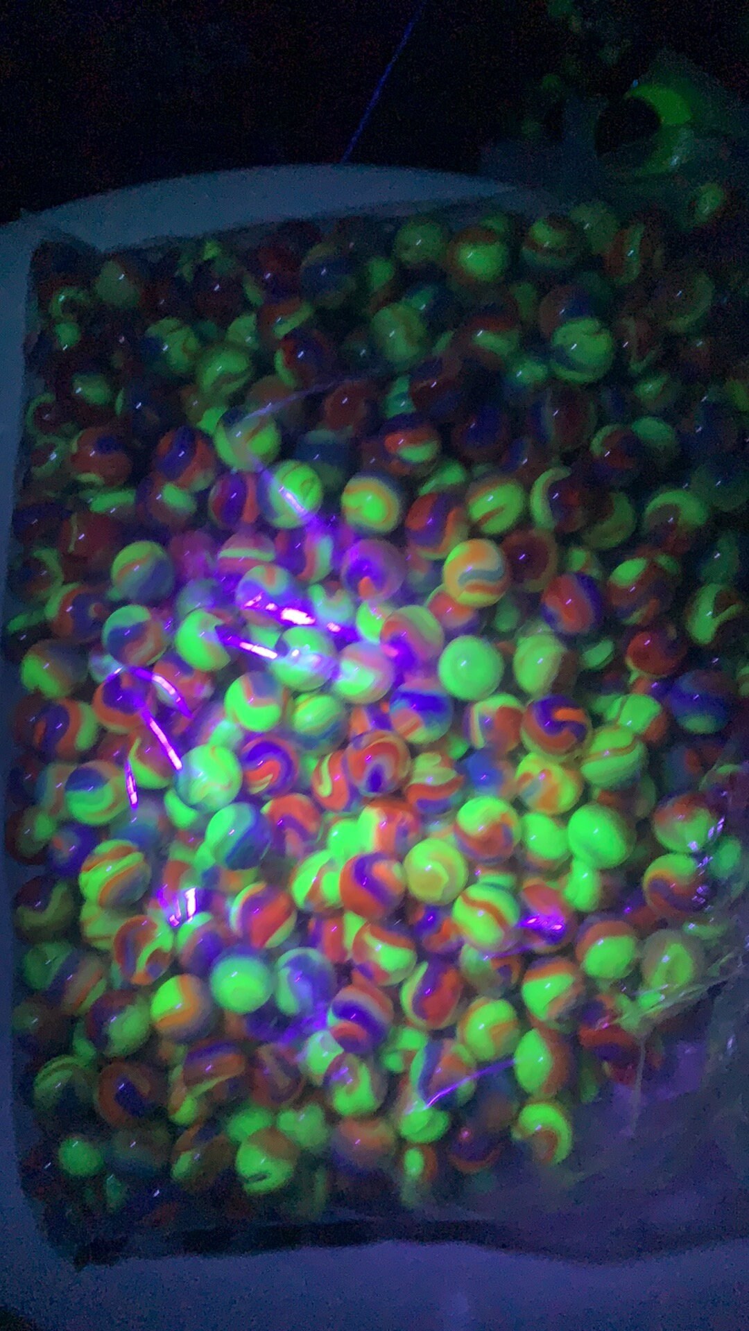 Received some marbles as a gift. They seem a little darker than normal  uranium glass but still fluoresce. The larger darker red marbles fluoresce  too although it's hard to see in the