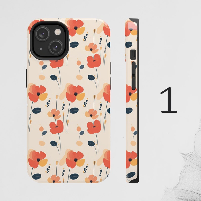 May include: A phone case with a floral pattern. The case is white with red, orange, and yellow flowers. The case has a cutout for the camera lens.