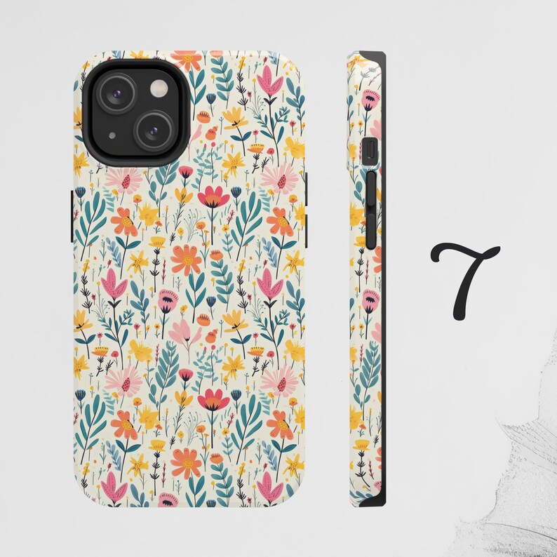 May include: A white phone case with a floral pattern featuring pink, yellow, orange, and blue flowers. The case has a black camera cutout and a black border.