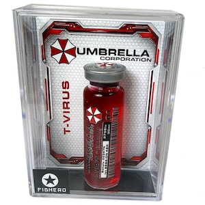 Könnte beinhalten: Eine transparente Kunststoff-Vitrine mit einem Fläschchen roter Flüssigkeit mit der Aufschrift "T-VIRUS" und dem Logo "Umbrella Corporation". Das Fläschchen hat einen silbernen Deckel und ein Etikett mit Text und einem rot-weißen Logo. Das Gehäuse hat einen schwarzen Stern und das Wort "FIGHERO".