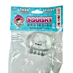 May include: A clear, squishy jelly toy in a plastic package. The toy is shaped like a jellyfish with a smiling face. The packaging is blue and features the words "Squishy" and "Sticky Jelly."