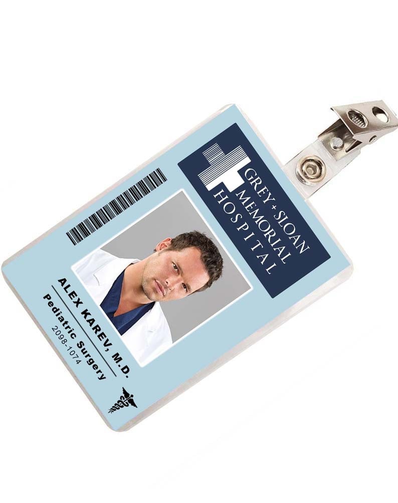 May include: A blue and white plastic ID badge with a photo of a man and the text "GREY+SLOAN MEMORIAL HOSPITAL" and "ALEX KAREV, M.D. Pediatric Surgery 2098-1074".
