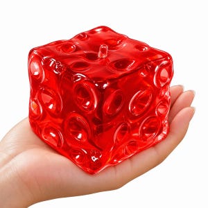 Puede incluir: Un cubo rojo translúcido con una superficie texturizada que presenta numerosas hendiduras circulares de varios tamaños. El objeto tiene un acabado brillante y una pequeña protuberancia en la cara superior, similar a un dado irregular.