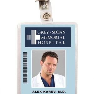 May include: A blue and white plastic ID badge with a photo of a man in a white coat. The badge reads "GREY + SLOAN MEMORIAL HOSPITAL" and "ALEX KAREV, M.D. Pediatric Surgery 2098-1074".