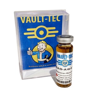 May include: A clear glass bottle containing a brown liquid. The bottle has a silver cap and a blue and white label that reads "Vault-Tec" and "Rad-Away Radiation Remedy". The bottle is positioned in front of a box with a blue and white label that says "Vault-Tec" and features the Vault-Tec logo.