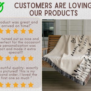 May include: A cream-colored throw blanket with black fringe is draped over a wooden swing. The blanket features a black floral design and the text "AMANDA & CONA 06-13-2025" with a heart symbol. The image also includes customer reviews.