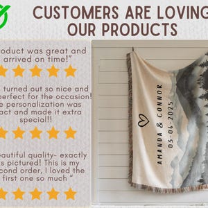 May include: A beige and gray landscape-themed throw blanket with a mountain and tree design. The blanket has a fringed edge and features the names "AMANDA & CONNOR" and the date "03-06-2025" with a heart symbol. The text "CUSTOMERS ARE LOVING OUR PRODUCTS" is also visible.