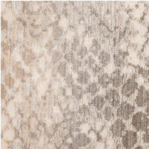 May include: Close-up of a textured rug with a pattern of gray and beige floral shapes. The rug has a soft, neutral color palette, with a mix of light and dark tones. The design is subtle and intricate.