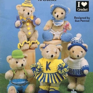 May include: A crochet pattern book featuring five teddy bears wearing different crocheted outfits. The book cover has the title "Teddy Bear Clothes To Crochet" and the text "I ♥ Crochet" with a heart. The book is designed by Sue Penrod.