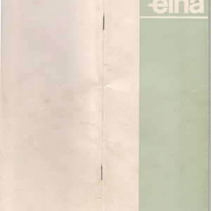 May include: A folded, white paper booklet with a green cover. The cover has the word "elna" printed in white letters.