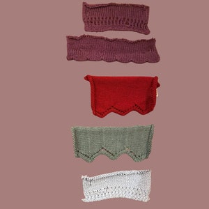May include: Five different knitted fabric samples with scalloped edges. The samples are in shades of purple, red, green, and gray.