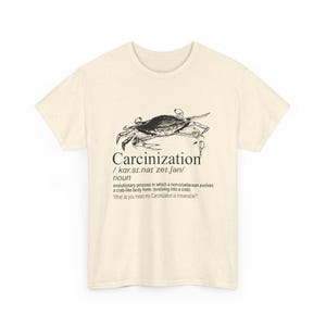 May include: Cream-colored t-shirt featuring a black and white illustration of a crab above the word "Carcinization" and its definition. The shirt's design includes the phonetic pronunciation and a quote about the evolutionary process.