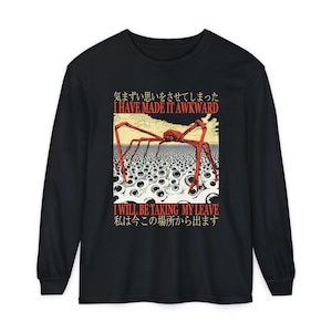May include: A black long-sleeve shirt featuring a graphic print of a red spider walking over a field of white eyeballs. The text reads: "気まずい思いをさせてしまった I HAVE MADE IT AWKWARD I WILL BE TAKING MY LEAVE 私は今この場所から出ます" in red and black.