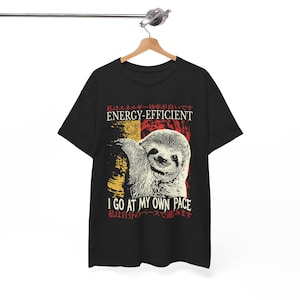 May include: Black t-shirt featuring a graphic of a sloth and the text "I go at my own pace". The text is in Japanese and English. The graphic is in a vintage style with red, yellow, and white colours.