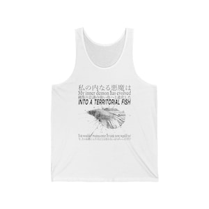 May include: A white vest top featuring a black graphic of a fish in the centre. The text reads: "My inner demon has evolved INTO A TERRITORIAL FISH. You wouldn't wanna enter its tank now, would ya?" along with Japanese characters above and below.