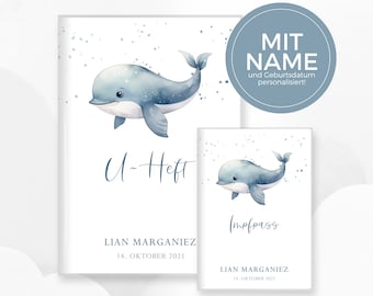 May include: Two blue and white watercolor dolphin illustrations on white cardstock. The larger illustration is on a card that says "U-Heft" and "LIAN MARGANIEZ 14. OKTOBER 2021". The smaller illustration is on a card that says "Impfpass" and "LIAN MARGANIEZ 14. OKTOBER 2021".