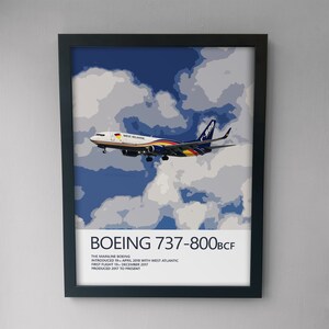 May include: A poster featuring a Boeing 737-800BCF airplane in flight against a blue sky with white clouds. The airplane is painted in the colors of West Atlantic Airlines. The poster includes the text "BOEING 737-800BCF", "THE MAINLINE BOEING", "INTRODUCED 19 APRIL 2018 WITH WEST ATLANTIC", "FIRST FLIGHT 19 DECEMBER 2017", and "PRODUCED 2017 TO PRESENT".