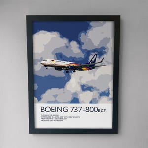 May include: A framed poster featuring a West Atlantic Boeing 737-800BCF airplane in flight against a blue and white cloudy sky. The text reads: BOEING 737-800BCF, THE MAINLINE BOEING, INTRODUCED 19TH APRIL 2018 WITH WEST ATLANTIC, FIRST FLIGHT 19TH DECEMBER 2017, PRODUCED 2017 TO PRESENT.