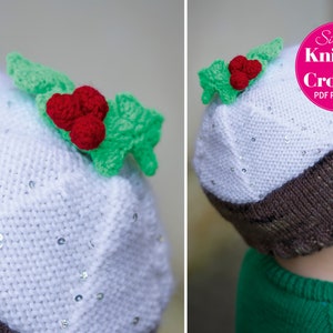 May include: White knitted hat with a brown brim, decorated with a green holly leaf and red berries. The hat is adorned with silver sequins. The hat is worn by a child wearing a green shirt.