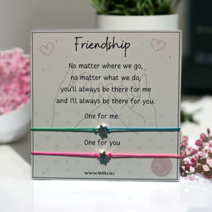 May include: Two friendship bracelets with silver star charms. The bracelets are green, blue, and pink. The card reads "Friendship" and includes the text "No matter where we go, no matter what we do, you'll always be there for me and I'll always be there for you. One for me. One for you. www.leelu.au"
