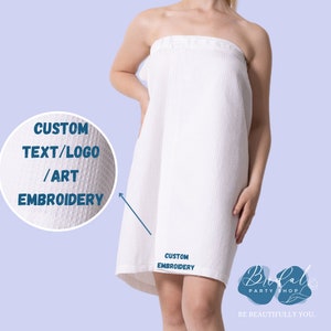 May include: A white waffle-weave spa wrap with the text "CUSTOM TEXT/LOGO/ART EMBROIDERY" and "CUSTOM EMBROIDERY". The wrap is shown on a person. The Bridal Party Shop logo is in the bottom right corner.