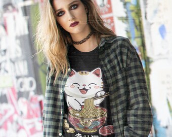 May include: A black t-shirt with a white cat cartoon illustration eating ramen noodles. The cat is smiling and holding chopsticks. The text "幸せ猫" is printed below the cat.
