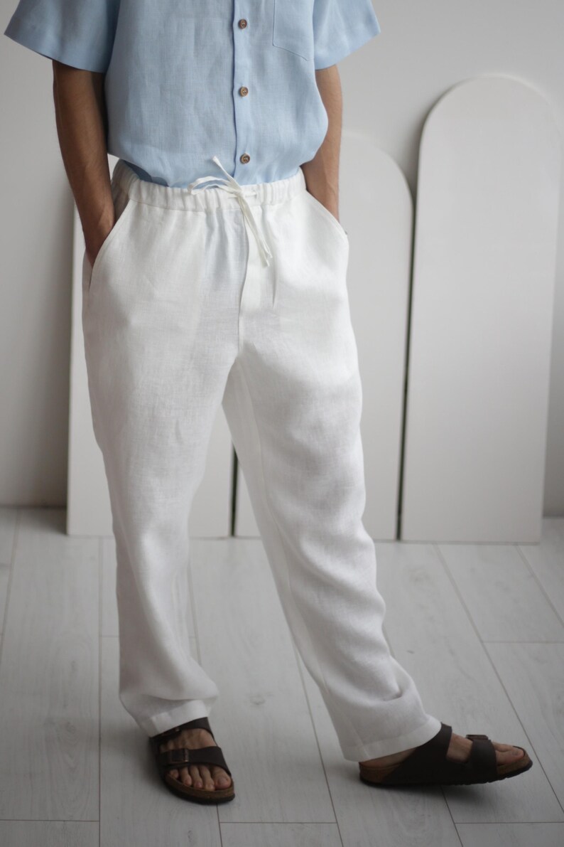 High-quality white linen pants FLORIDA with a classic design, featuring side pockets and a soft elastic waistband, perfect for summer casual wear.