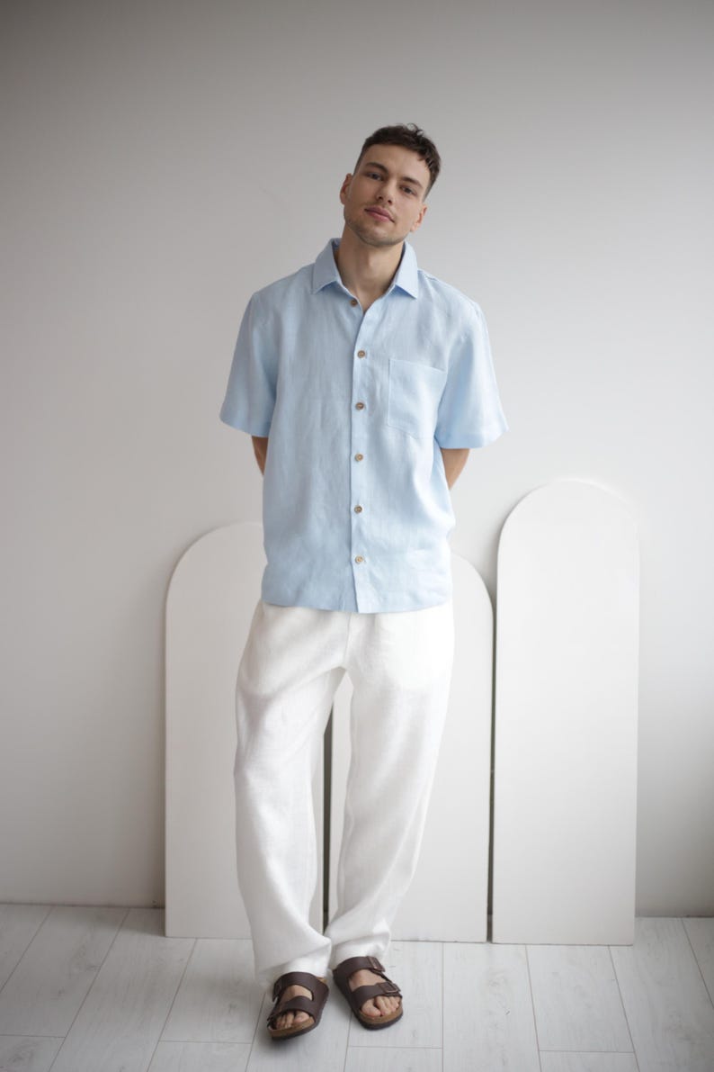 Man wearing FLORIDA white linen pants, showcasing a smart casual summer look, paired with a simple shirt.