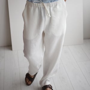 Close-up image of the linen pants, showing the breathable, soft texture and side pockets, ideal for easy, stylish wear in hot weather.