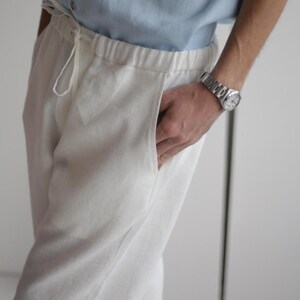 Close-up of men's white linen pants FLORIDA showing fine stitching and soft, high-quality linen fabric.