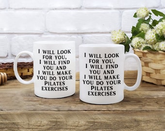 May include: Two white ceramic mugs with black text that reads "I will look for you, I will find you and I will make you do your Pilates exercises".