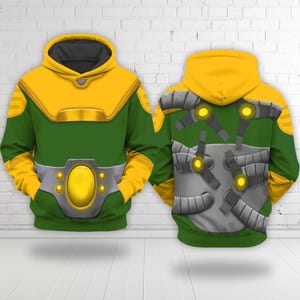 May include: A green and yellow hooded sweatshirt with a superhero costume design. The front features a yellow collar and belt with a large oval center. The back has a gray armor design with yellow accents.