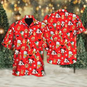 May include: Red short-sleeved button-down shirt featuring a festive pattern of Disney characters in Santa hats, scarves, and gingerbread men. The design includes Mickey Mouse, Donald Duck, and Goofy, with snowflakes and gingerbread houses.