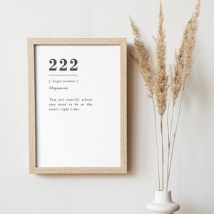 May include: A framed print with the number 222 and the text "[ Angel number ] Alignment You are exactly where you need to be at the exact right time."
