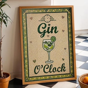May include: A framed mosaic art piece with the words "Gin O'Clock" and a cocktail glass illustration. The artwork features a green and beige color scheme, with a wooden frame. A potted plant and a basket of oranges are in the foreground.