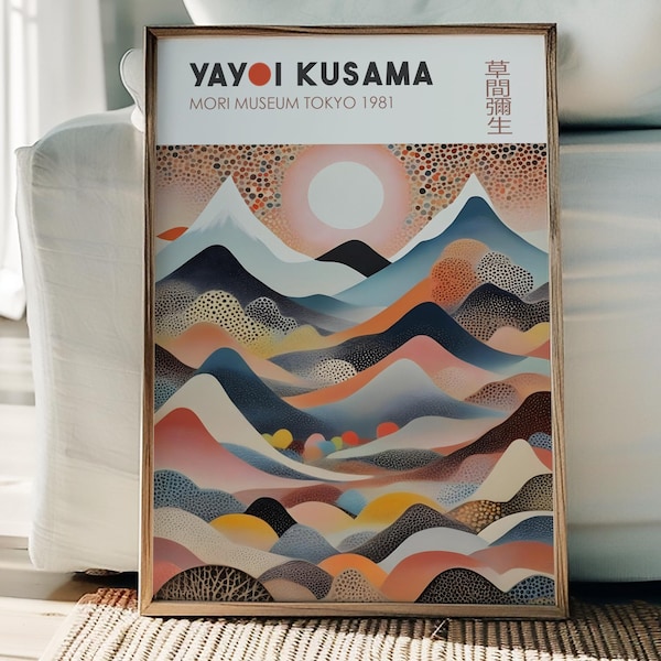 May include: A framed art print featuring a colorful landscape with mountains, a sun, and dotted patterns. The print includes the text "YAYOI KUSAMA MORI MUSEUM TOKYO 1981" in a white rectangular box. The artwork is displayed on a white couch.
