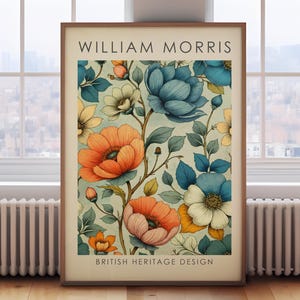 May include: A framed print with a floral pattern in shades of orange, blue, and white, with green foliage. The print, in a wooden frame, is labelled "WILLIAM MORRIS" and "BRITISH HERITAGE DESIGN". The background is a light blue colour.