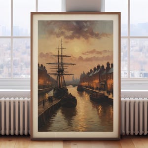 May include: A framed vintage painting depicts a canal scene at dusk. A tall ship is docked along a stone walkway, with buildings lining the waterway. The sky is filled with warm, golden light, and the water reflects the scene.