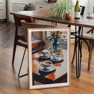 May include: A framed print of a still life painting featuring a table setting with four cups of coffee, a vase of flowers, and a glass of juice. The painting is set against a window with sunlight streaming in.