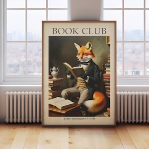 May include: Framed art print featuring a fox in formal attire reading a book, with the text "BOOK CLUB" at the top. The print has a vintage aesthetic, with the words "EVERY WEDNESDAY 7-9 PM" at the bottom. The fox is depicted with orange fur and a distinguished appearance.