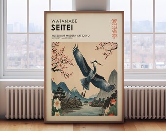 May include: A vintage poster for the Watanabe Seitei exhibition at the Museum of Modern Art Tokyo. The poster features a Japanese-style illustration of a blue heron flying over a mountain landscape with cherry blossoms. The text on the poster reads "Watanabe Seitei" and "Museum of Modern Art Tokyo" in English and "渡辺省亭" in Japanese.