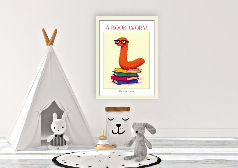 May include: A framed illustration of an orange bookworm wearing glasses and sitting on a stack of colorful books. The text "A Book Worm" is above the bookworm and the text "Reads here" is below the bookworm.