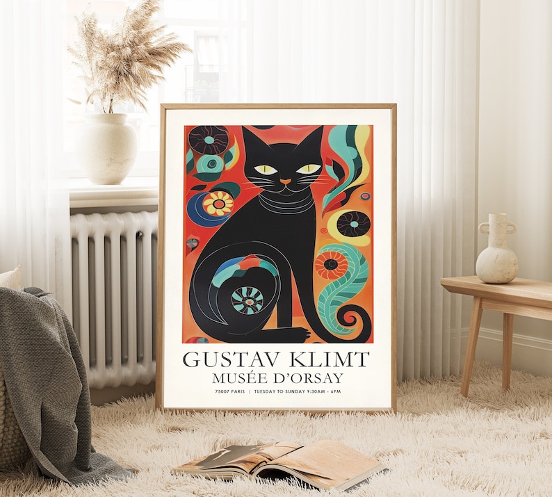 May include: A black cat with a colourful background. The cat is sitting with its tail curled around its body. The background is a mix of red, orange, yellow, green, and blue. The text on the poster reads "Gustav Klimt Mus&eacute;e d'Orsay 75007 Paris | Tuesday to Sunday 9:30am - 6pm".