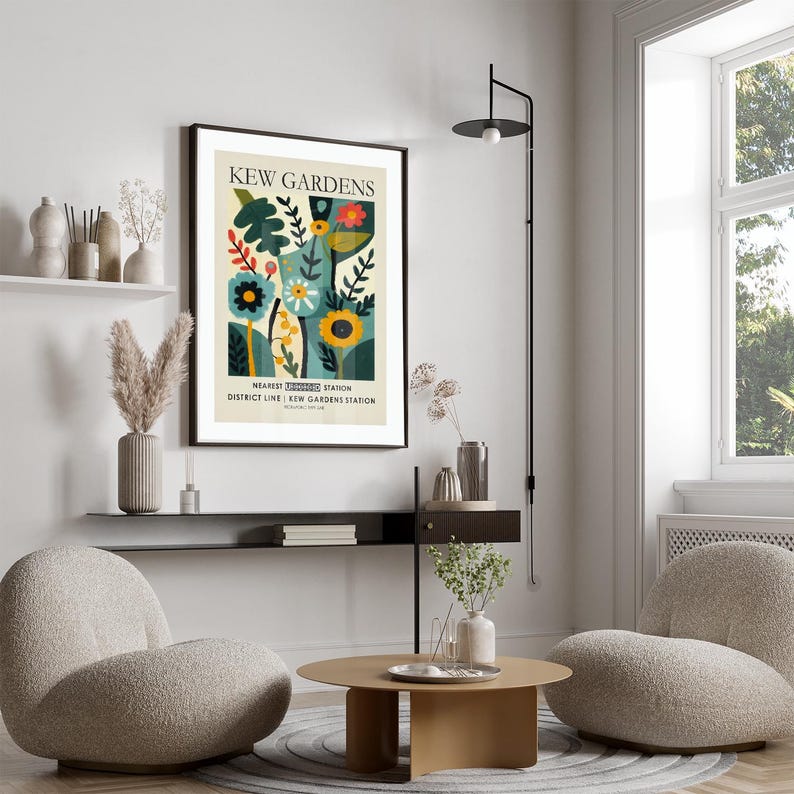 May include: A framed art print featuring a colorful floral design with the text "KEW GARDENS". The artwork includes stylized flowers, leaves, and the text "NEAREST UNDERGROUND STATION DISTRICT LINE | KEW GARDENS STATION". The print is displayed in a modern living room setting.