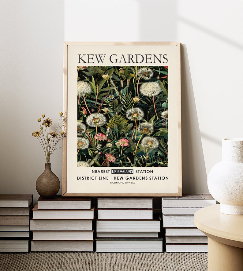 May include: A framed print with a botanical illustration of dandelions and other plants on a dark green background. The print has the text "KEW GARDENS" at the top and "NEAREST UNDERGROUND STATION DISTRICT LINE | KEW GARDENS STATION RICHMOND TW9 3AE" at the bottom.