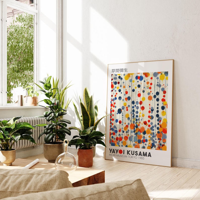 May include: A colorful abstract art print featuring a pattern of red, yellow, and blue circles on a white background. The print is titled "Yayoi Kusama" and includes the text "Mori Museum Tokyo 1985".