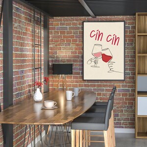 May include: A modern dining room with a wooden table and black chairs. A framed print with the text "cin cin" and a drawing of two wine glasses clinking together hangs on a brick wall.